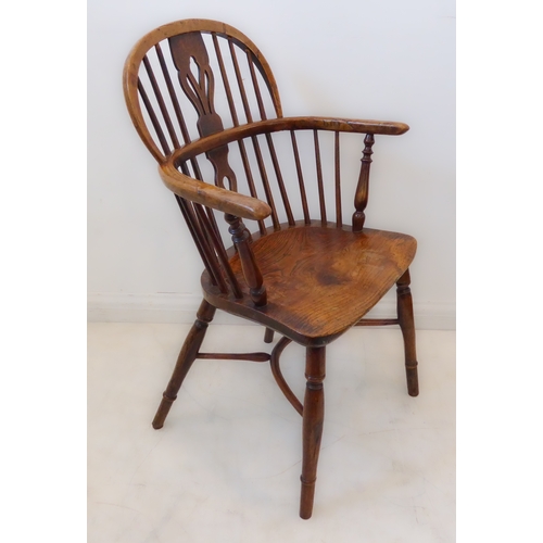 409 - A mid-19th century fruitwood Windsor chair: pierced splat and spindle back above a shaped bow and sh... 