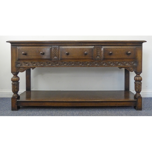 510 - (matches 21598-2) The matching reproduction oak dresser base of very fine quality: the moulded top e... 