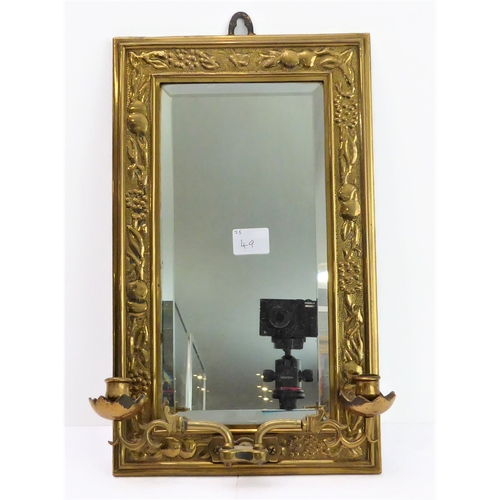 363 - A late 19th/early 20th century brass framed two-light girandole: floral and foliate decorated repous... 