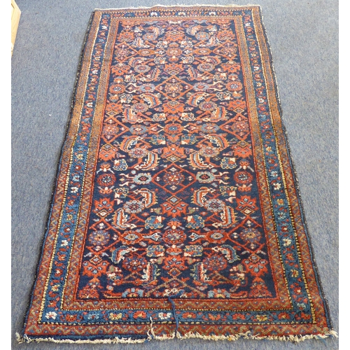 398 - An early to mid 20th century hand-knotted carpet (possibly Turkish): cobalt-blue rectangle with vary... 