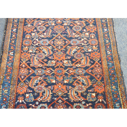 398 - An early to mid 20th century hand-knotted carpet (possibly Turkish): cobalt-blue rectangle with vary... 