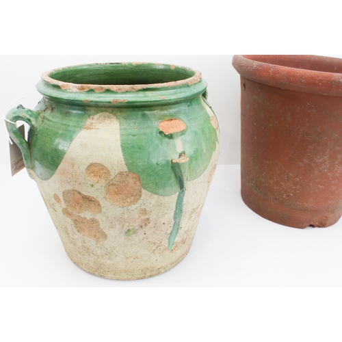 22 - An antique French partially green-glazed pottery confit jar (27.5 cm high) and a similar sized terra... 