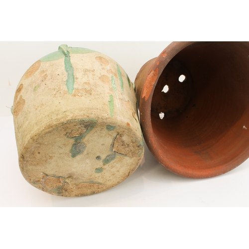22 - An antique French partially green-glazed pottery confit jar (27.5 cm high) and a similar sized terra... 