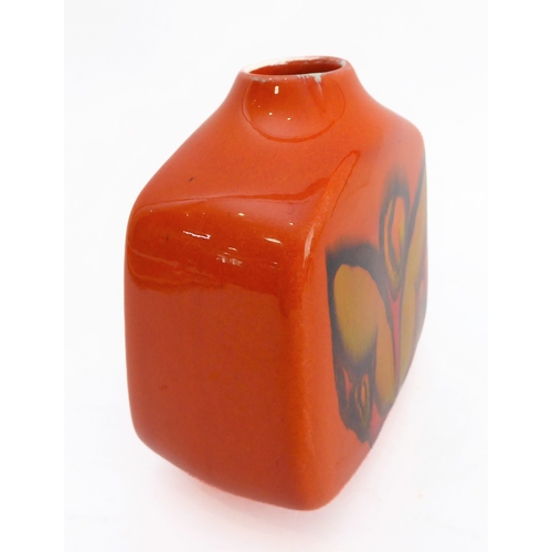 24 - Two pieces:
 1. a Poole Pottery 'Delphis' boat-shaped studioware dish with 'Poole - England - 82' pa... 