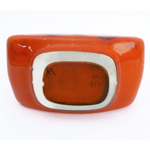 24 - Two pieces:
 1. a Poole Pottery 'Delphis' boat-shaped studioware dish with 'Poole - England - 82' pa... 