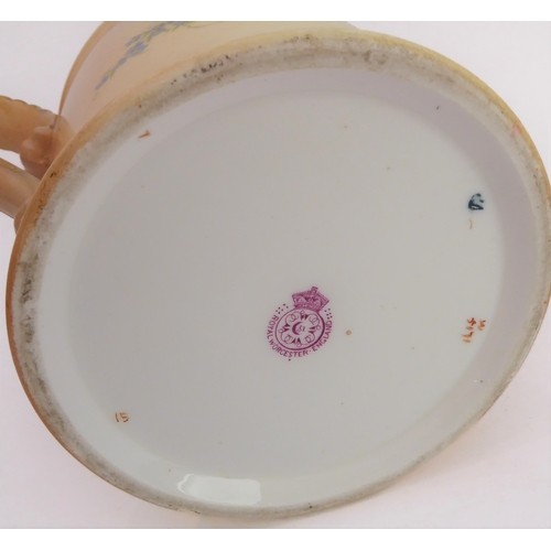 32 - An early 20th century Royal Worcester blush porcelain loving cup: two-handled and hand-decorated in ... 