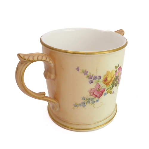 32 - An early 20th century Royal Worcester blush porcelain loving cup: two-handled and hand-decorated in ... 