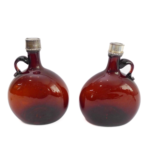 56 - A pair of 19th century silver-mounted brown-glass flasks: the circular silver tops and neck ferrules... 