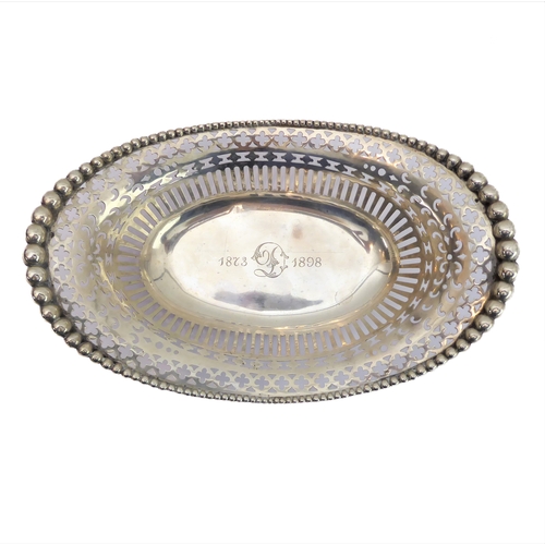 80 - A late 19th century sterling silver reticulated boat-shaped bowl, monogrammed 'D' and engraved '1873... 
