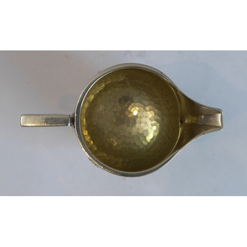 103 - A good hand-planished, hallmarked silver three-piece Arts and Crafts tea service to comprise: 
 a te... 