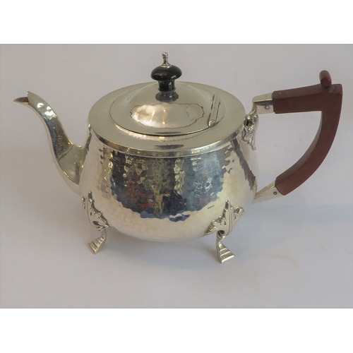 103 - A good hand-planished, hallmarked silver three-piece Arts and Crafts tea service to comprise: 
 a te... 