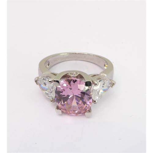 108 - A lady's hallmarked silver ring centrally set with a large hand-cut oval pink stone of good colour, ... 
