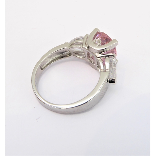 108 - A lady's hallmarked silver ring centrally set with a large hand-cut oval pink stone of good colour, ... 