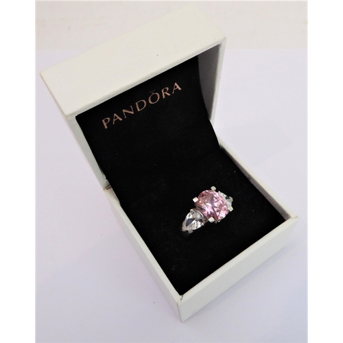 108 - A lady's hallmarked silver ring centrally set with a large hand-cut oval pink stone of good colour, ... 