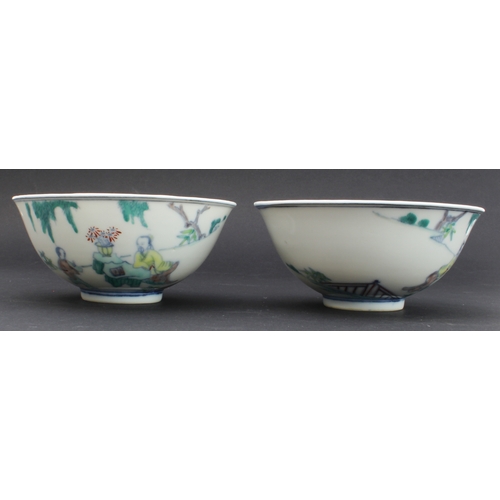 34 - A pair of modern Chinese porcelain bowls in 18th century style: each decorated with an exterior scen... 