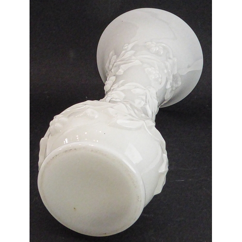 46 - A Napoleon III period (1845-1870) Baccarat opaline vase of trumpet form and decorated in high relief... 