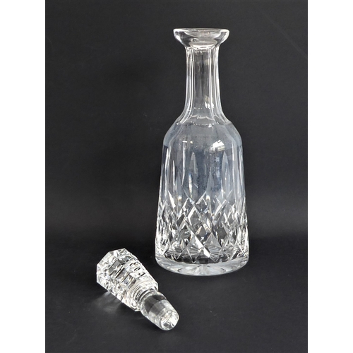 52 - Four quality glass decanters:
 a modern hand-cut mallet-shaped decanter and stopper ;
 a hand-cut sp... 
