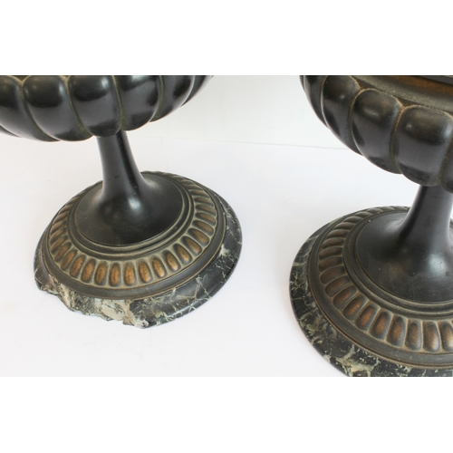 60 - A pair of late 19th to early 20th century two-handled patinated (bronze?) vases on circular black an... 