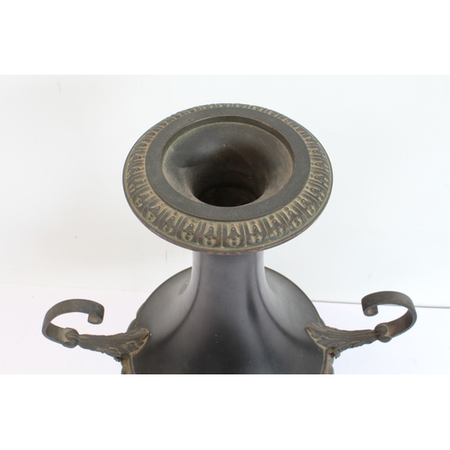 60 - A pair of late 19th to early 20th century two-handled patinated (bronze?) vases on circular black an... 