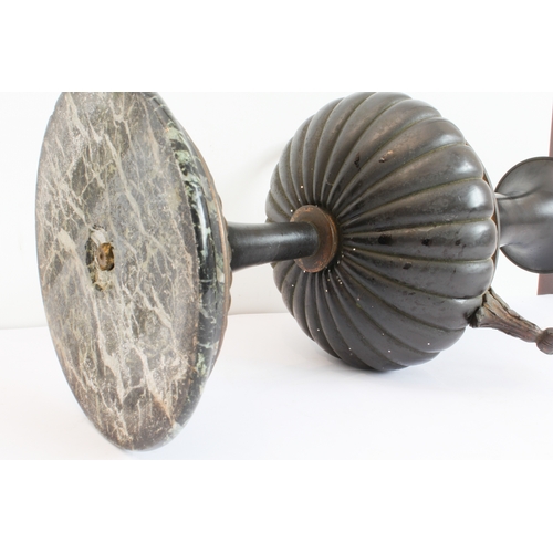 60 - A pair of late 19th to early 20th century two-handled patinated (bronze?) vases on circular black an... 