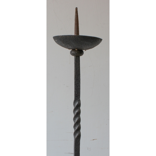 69A - A large wrought iron pricket stick with unusual central heart motif and raised on tripod base (159cm... 