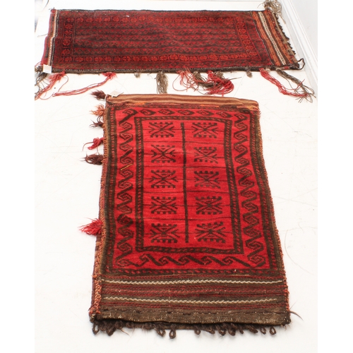 331 - Two early to mid 20th century hand-woven tribal saddlebags with red grounds and stylised repeating p... 