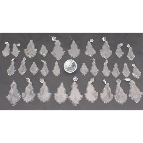 56A - A large and showy pair of gilt metal and cut-glass, 12 light chandeliers: varying tiers with individ... 