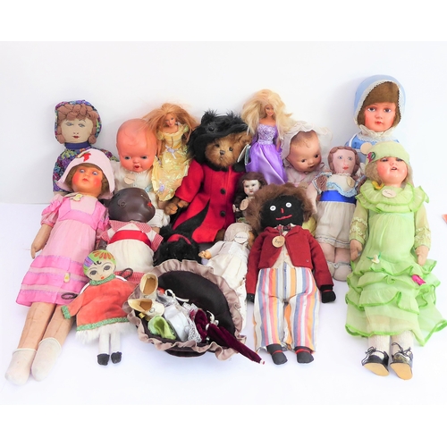 149 - Fifteen collector's dolls to include composition dolls and a bear dressed in long red coat with dog ... 