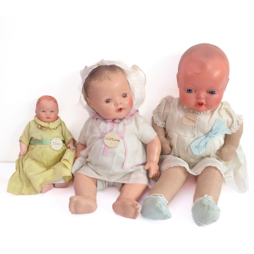 149 - Fifteen collector's dolls to include composition dolls and a bear dressed in long red coat with dog ... 