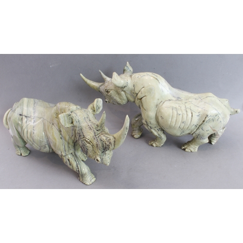 171 - A pair of heavy carved stone rhinoceri Buttqsade (Shona), Rhodesia, realistically modelled from band... 