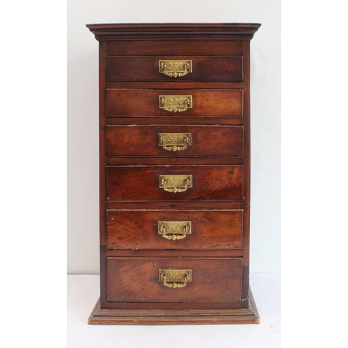 178 - A late 19th century tabletop bank of mahogany/fruitwood (?) drawers: cleated slightly overhanging mo... 