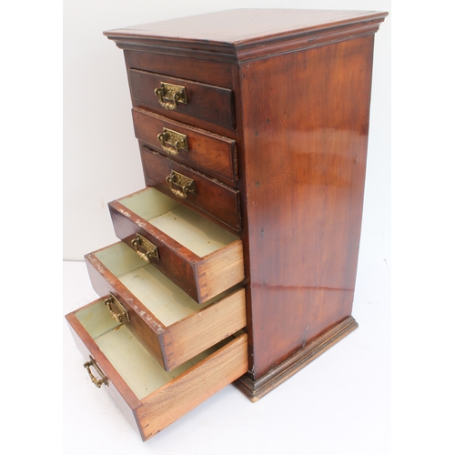 178 - A late 19th century tabletop bank of mahogany/fruitwood (?) drawers: cleated slightly overhanging mo... 