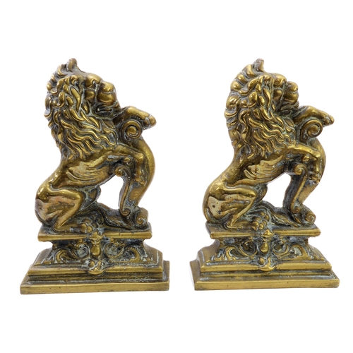 49 - A good and unusual pair of brass and lead-weighted doorstops modelled as lions coward (34 cm high)