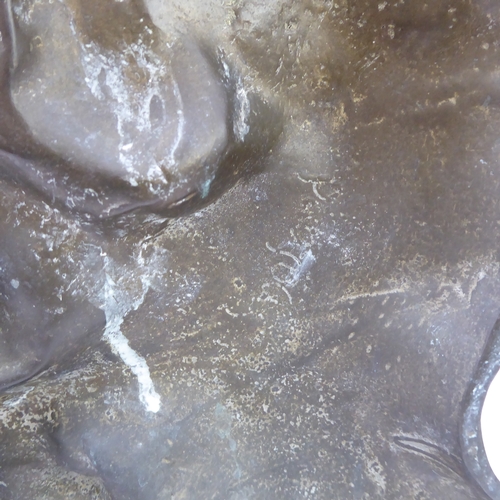 49 - A good and unusual pair of brass and lead-weighted doorstops modelled as lions coward (34 cm high)