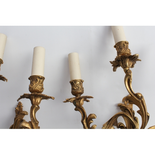 54 - A pair of early 20th century gilt-metal three-light wall appliques in high mid-18th century Rococo s... 