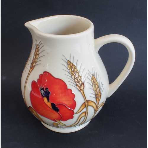 11 - A modern Moorcroft pottery jug of of Art Nouveau inspiration: baluster form, decorated with poppies ... 