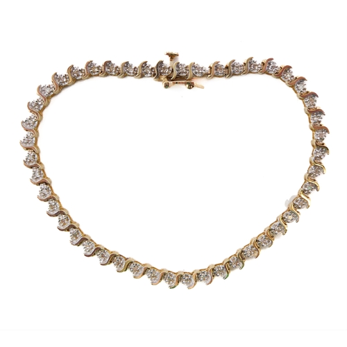 121 - A 14ct gold and diamond tennis bracelet (marked 14K to the clasp), each link illusion set a single c... 