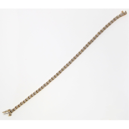 121 - A 14ct gold and diamond tennis bracelet (marked 14K to the clasp), each link illusion set a single c... 