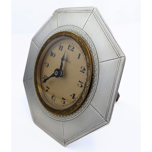 126 - *** DESCRIPTION REVISED *** An eight-day bedside-style clock: octagonal hallmarked silver frame; bei... 