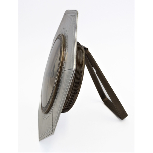 126 - *** DESCRIPTION REVISED *** An eight-day bedside-style clock: octagonal hallmarked silver frame; bei... 