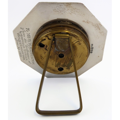126 - *** DESCRIPTION REVISED *** An eight-day bedside-style clock: octagonal hallmarked silver frame; bei... 