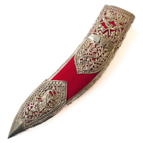 131 - A modern kukri and white-metal-mounted Saudi-style red-felt sheath: heavy carved handle with brass c... 