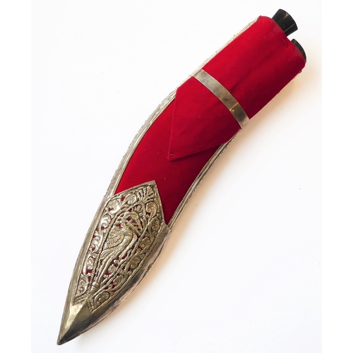 131 - A modern kukri and white-metal-mounted Saudi-style red-felt sheath: heavy carved handle with brass c... 
