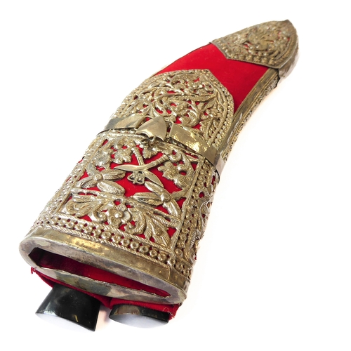 131 - A modern kukri and white-metal-mounted Saudi-style red-felt sheath: heavy carved handle with brass c... 