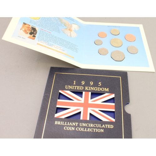 136 - Nine Royal Mint commemorative coins, coin sets and crowns: 
 3 x £5 coins (2003 Coronation Jubilee, ... 