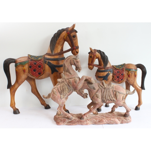 167 - Two hand-carved painted wooden ornamental horses (the larger 61 x 51.5 cm) and a terracotta model of... 