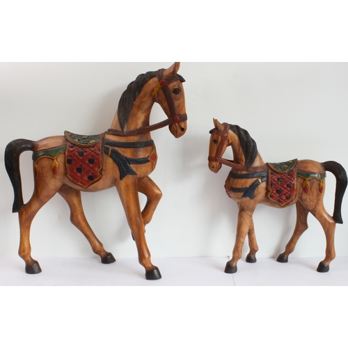 167 - Two hand-carved painted wooden ornamental horses (the larger 61 x 51.5 cm) and a terracotta model of... 