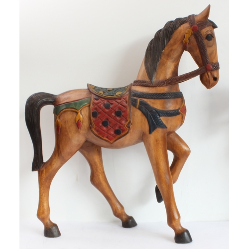167 - Two hand-carved painted wooden ornamental horses (the larger 61 x 51.5 cm) and a terracotta model of... 