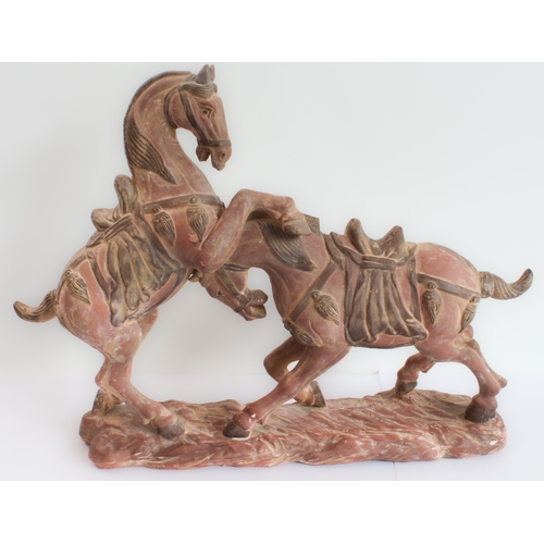 167 - Two hand-carved painted wooden ornamental horses (the larger 61 x 51.5 cm) and a terracotta model of... 