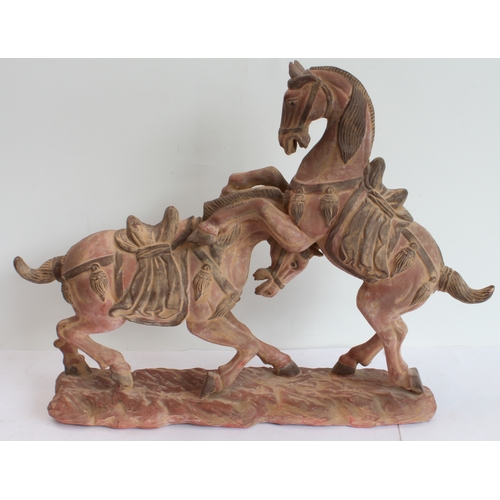 167 - Two hand-carved painted wooden ornamental horses (the larger 61 x 51.5 cm) and a terracotta model of... 